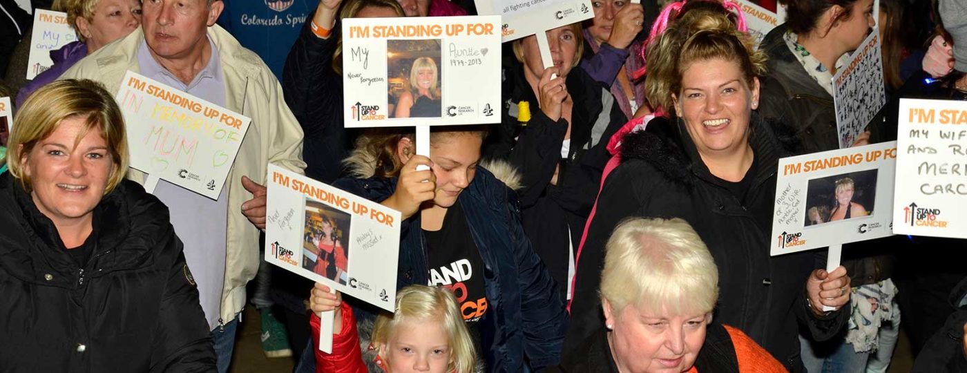 group of people stand up to cancer event