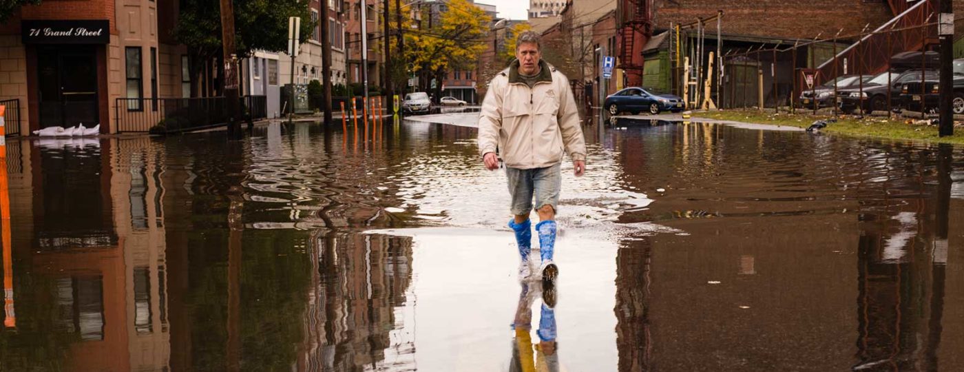 man walking on street aftermath hurricane preparedness