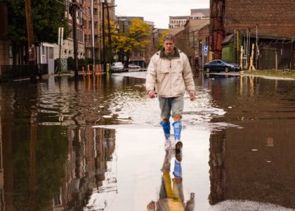 man walking on street aftermath hurricane preparedness