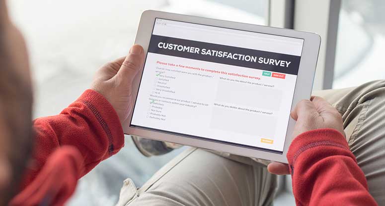 satisfied customer taking survey using a tablet