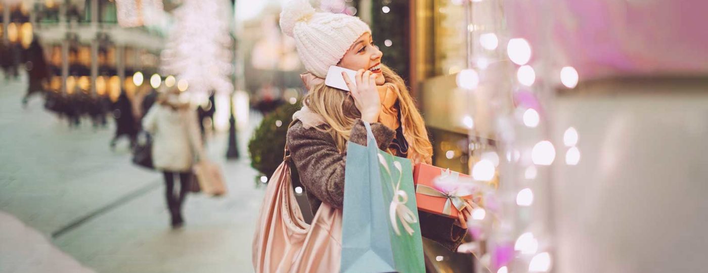 woman talking on the phone shopping during the holidays