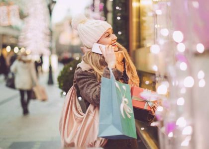 woman talking on the phone shopping during the holidays