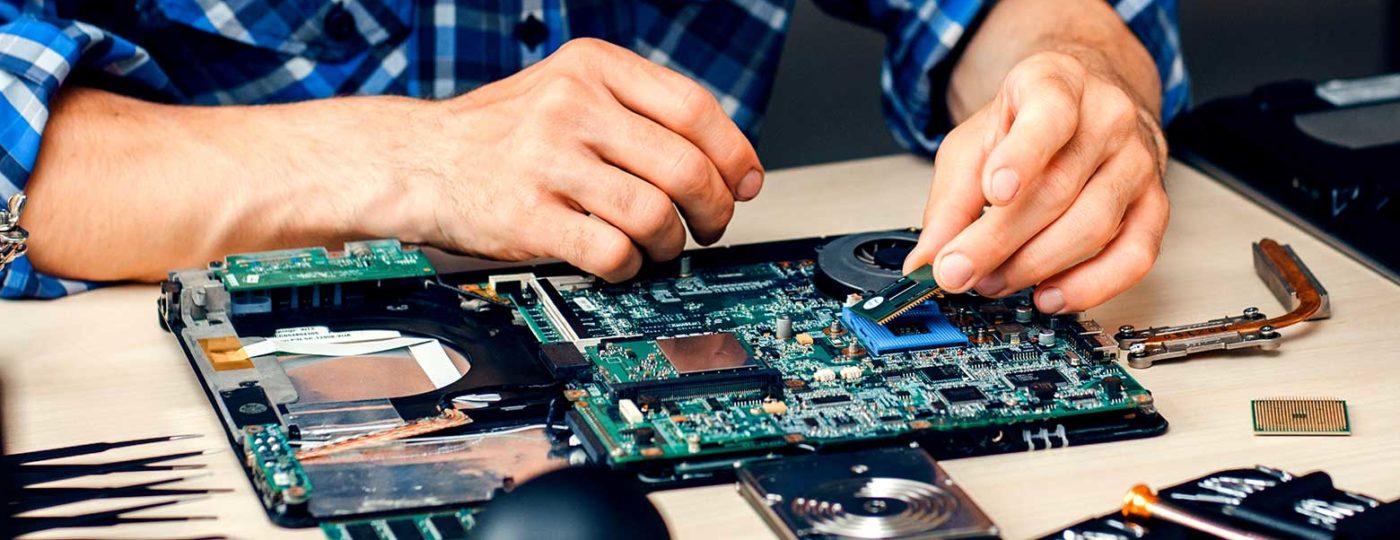 hands fixing an electronic circuit