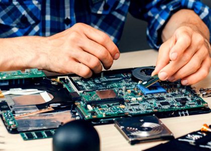 hands fixing an electronic circuit