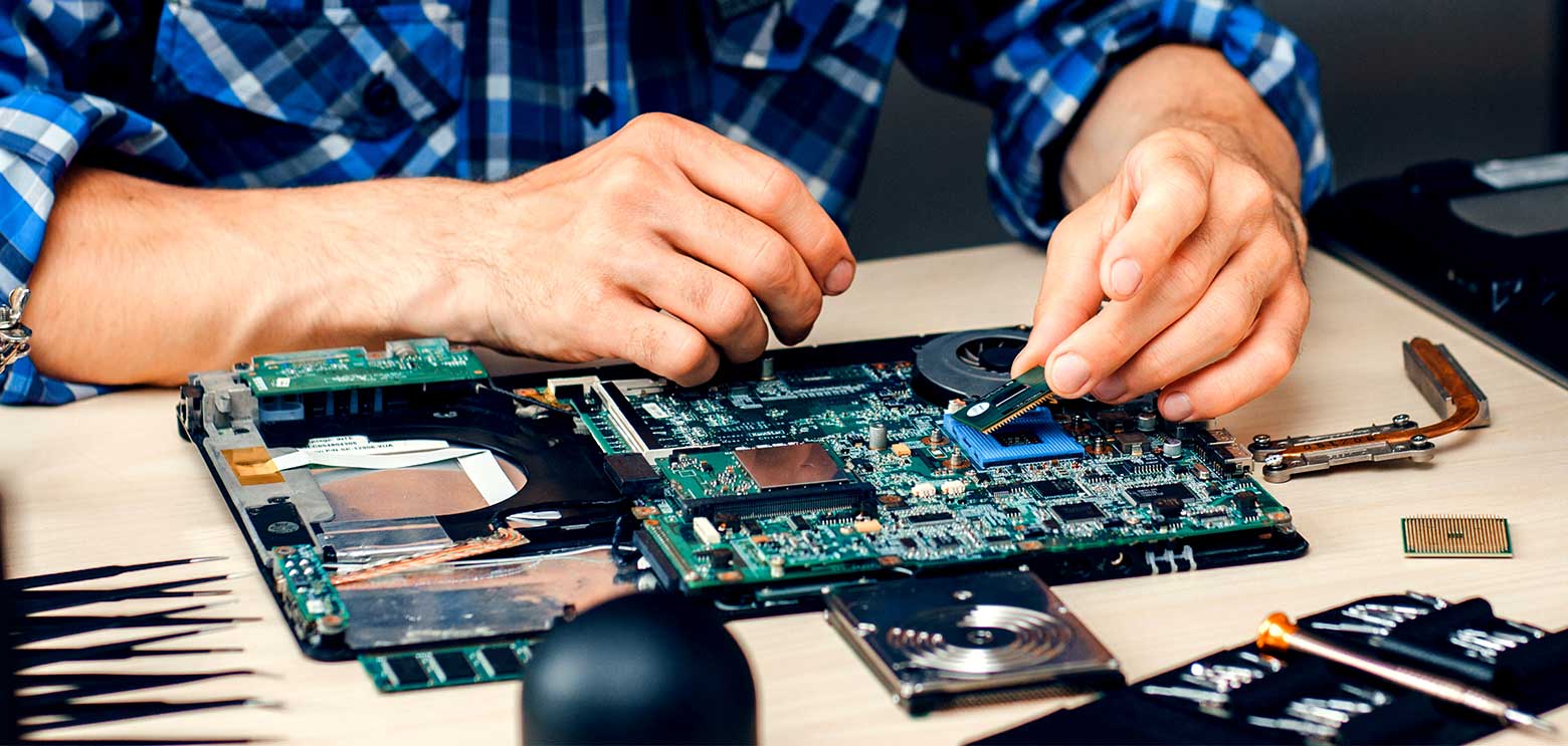 hands fixing an electronic circuit