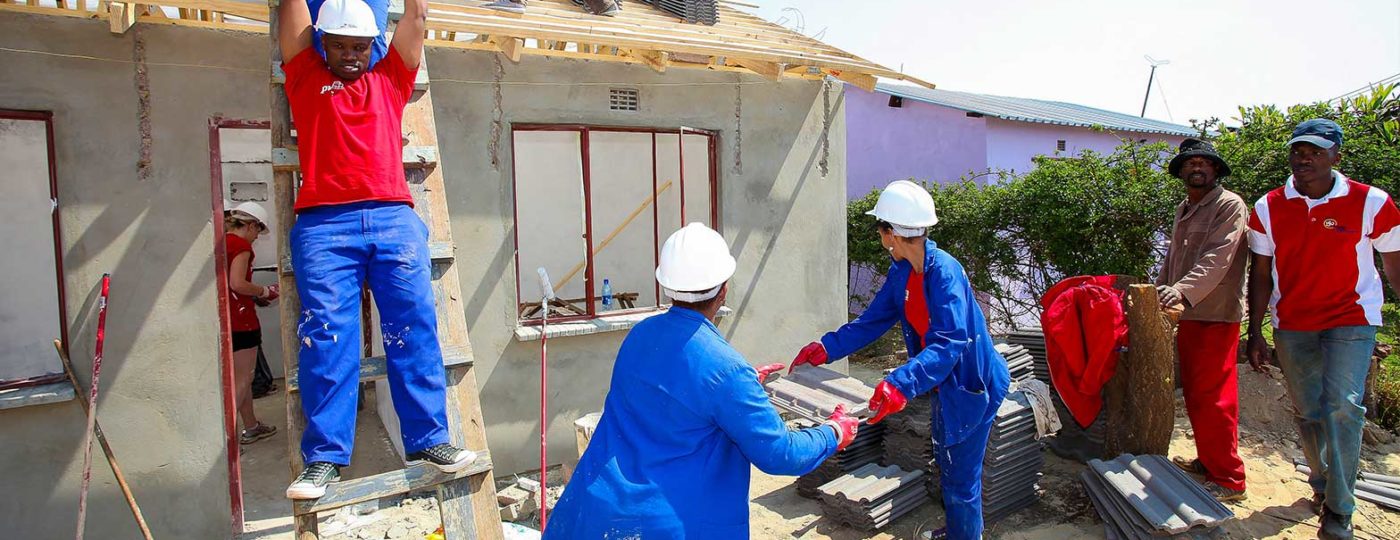 group of volunteers rebuilding houses in areas where natural disaster destroy houses
