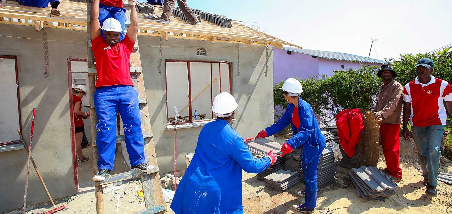 group of volunteers rebuilding houses in areas where natural disaster destroy houses