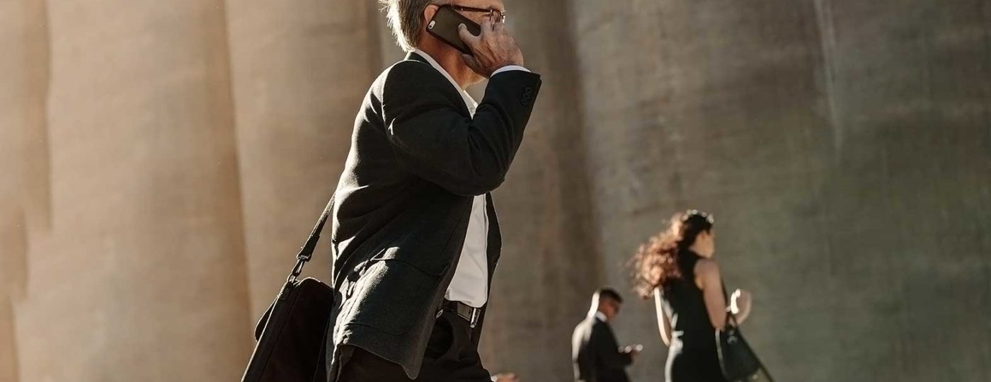business man with mobile phone in hand getting virtual on demand call center solutions