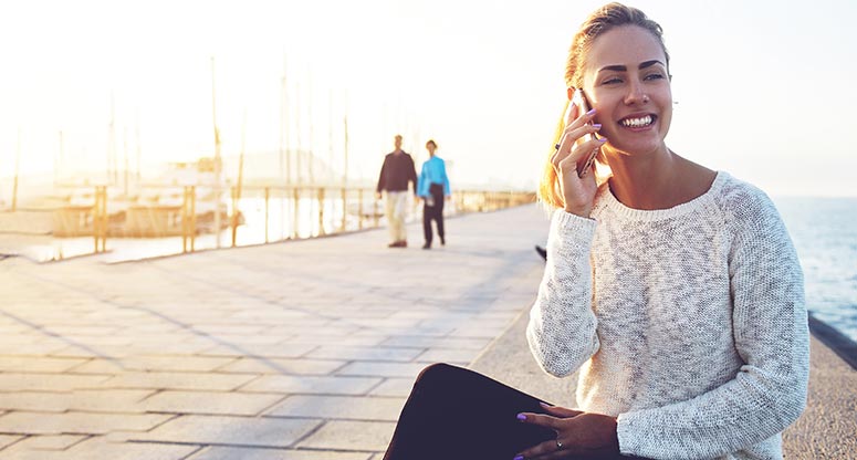 woman on mobile phone getting service from on demand contact center customer experience solutions