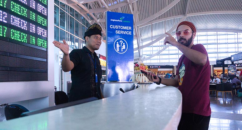 man at airport getting directions from airport worker