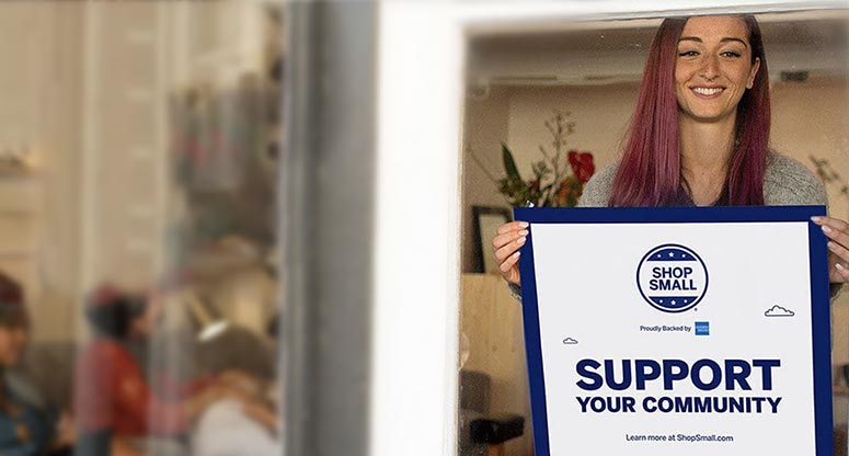 woman holding a small business Saturday sign
