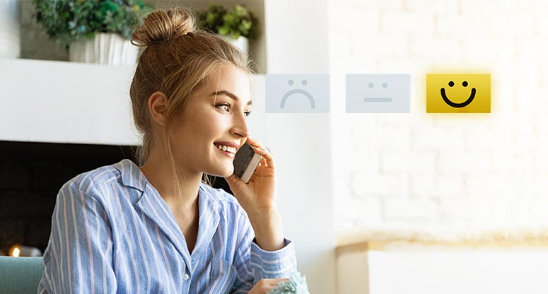 woman talking on the phone with on demand contact center solutions with a happy face 