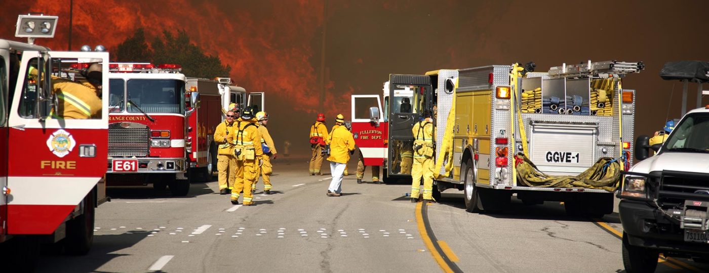 fire trucks trying parked while firemen try to control wild fire for disaster recovery services from contact center solutions