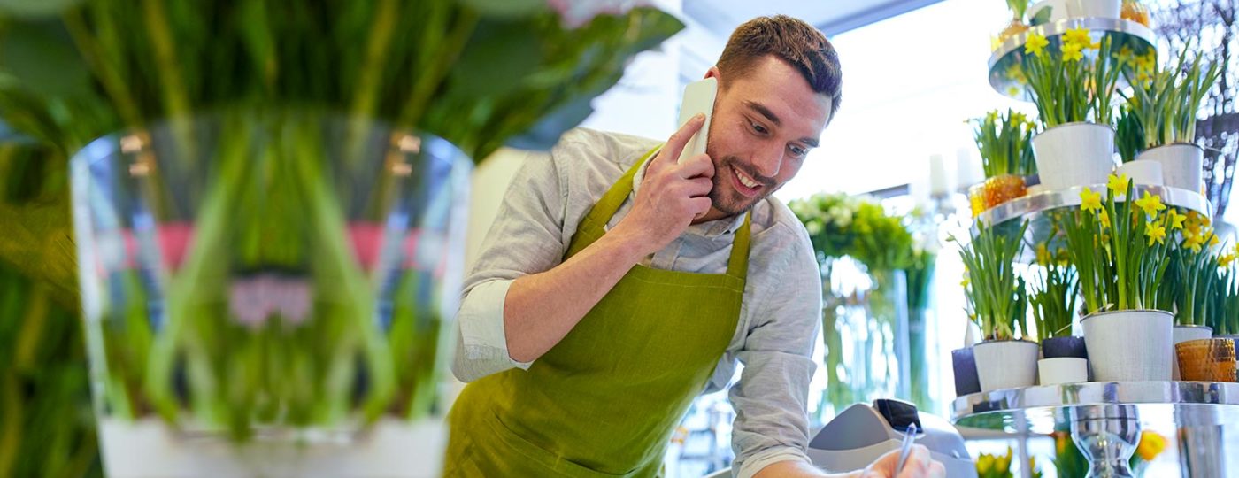 man working at a retail worker store talking to on demand on demand contact center service