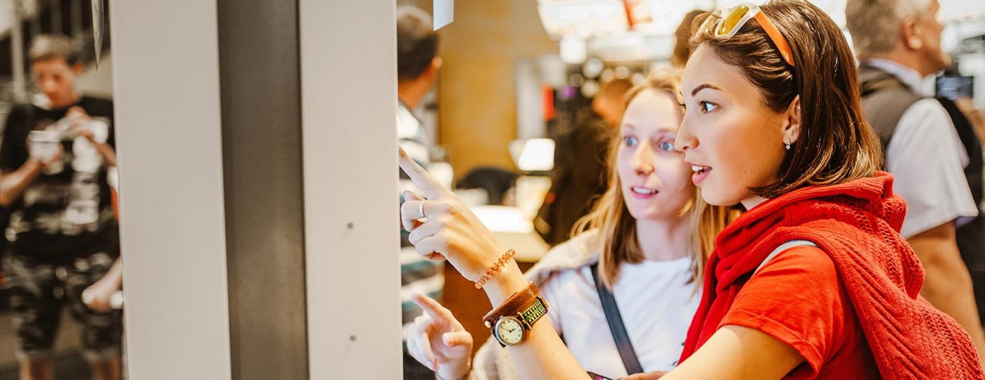 two women getting fast customer service from on demand contact center customer service inside a restaurant