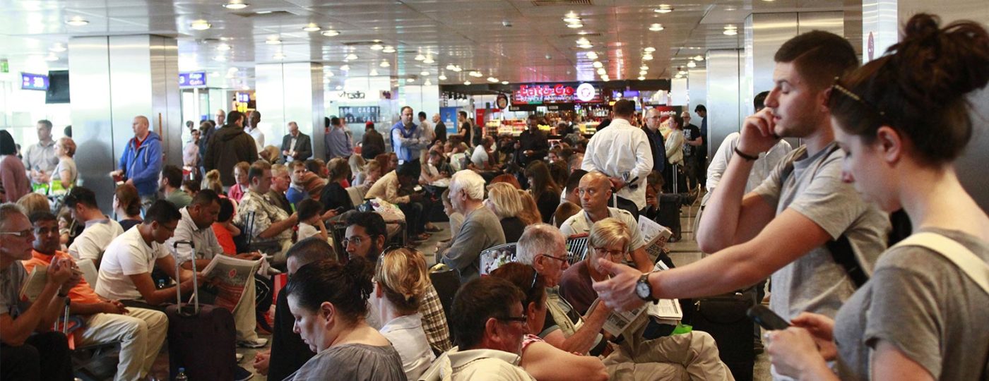 people waiting at airport for next available flight man talking to on demand contact center solutions agent