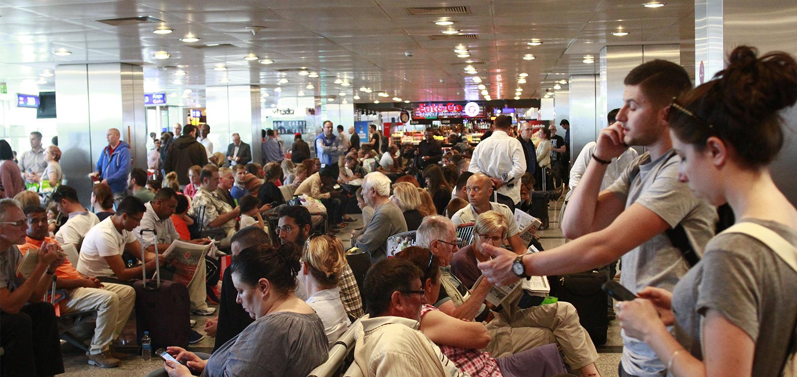 people waiting at airport for next available flight man talking to on demand contact center solutions agent