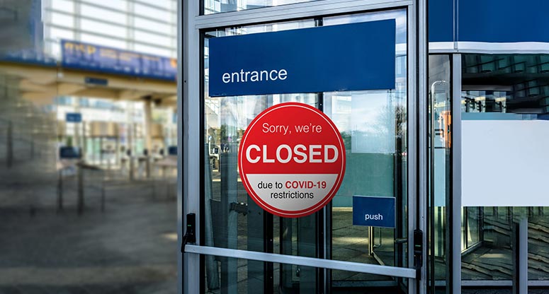 door with a closed sign due to coronavirus-19 pandemic
