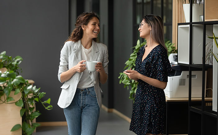Two women having a conversation in an office space