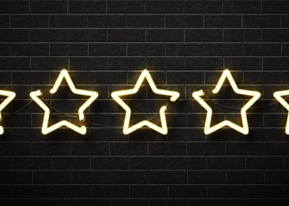 Five stars made out of neon lights against a black brick wall