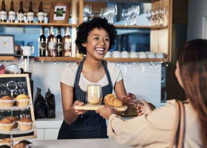 Barista serves customer in a caffe