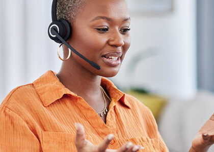 Work from home agent talks joyfully with a customer through her headset