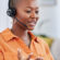 Work from home agent talks joyfully with a customer through her headset