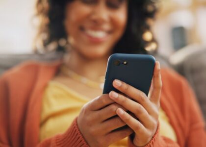 Happy person holds their phone as they experience a good customer experience